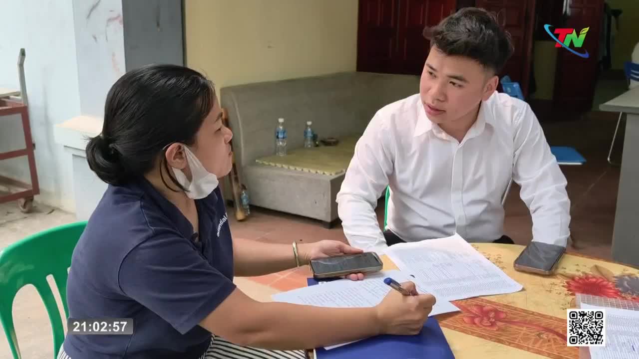 A woman in a dark blue shirt and a man in a white dress shirt sit at a table, reviewing documents. The woman holds a pen and a phone, while the man gestures with his hands as he speaks. A woman in a dark blue shirt and a man in a white dress shirt sit at a table, reviewing documents. The woman holds a pen and a phone, while the man gestures with his hands as he speaks.