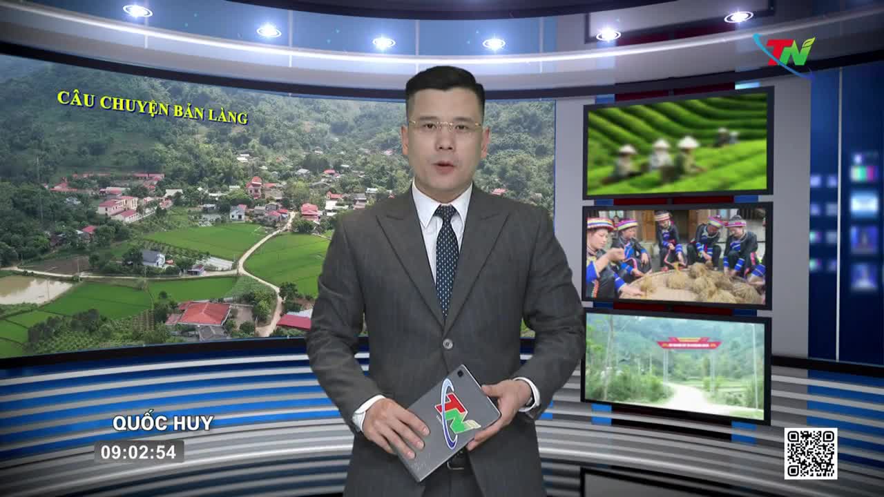 A man in a suit stands before a screen showing a Vietnamese village. Three smaller screens to his right display scenes of tea harvesting, people in traditional dress, and a rural road. A man in a suit stands before a screen showing a Vietnamese village. Three smaller screens to his right display scenes of tea harvesting, people in traditional dress, and a rural road.