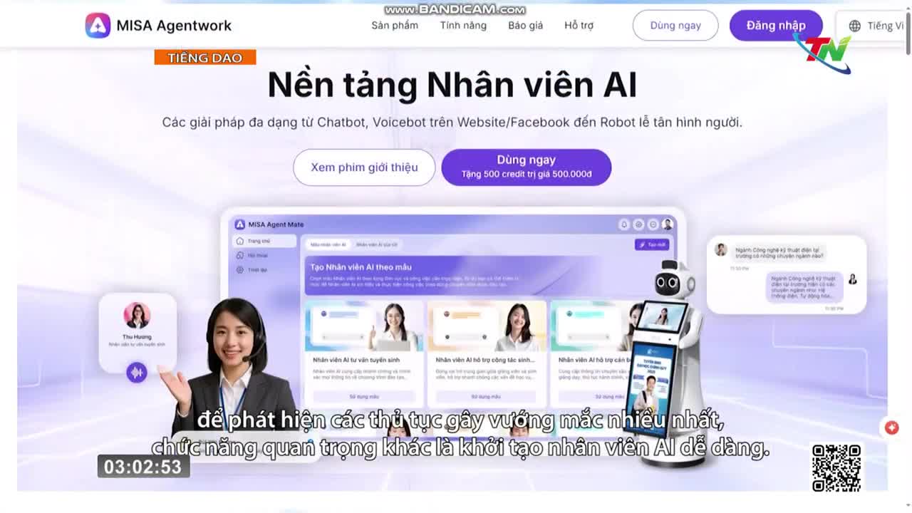 A woman in a headset smiles and gestures towards a screen displaying an AI assistant platform. A white robot with a screen stands beside her, showcasing a chat interface. A woman in a headset smiles and gestures towards a screen displaying an AI assistant platform. A white robot with a screen stands beside her, showcasing a chat interface.