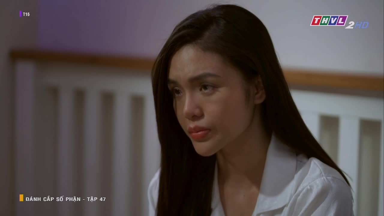 A woman with long, dark hair looks down, her expression somber. The episode of the Vietnamese TV show, "ĐÁNH CẮP SỐ PHẬN," is playing on Tra Vinh TV.
