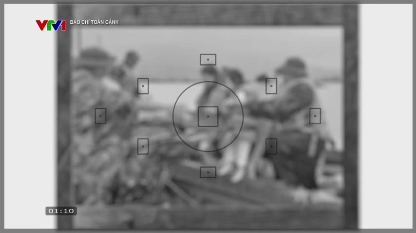 The scene, broadcast on VTV1, is framed by a viewfinder, with soldiers in the background. It's a black and white image, likely from Vietnam, with a time stamp of 01:10 in the corner.

