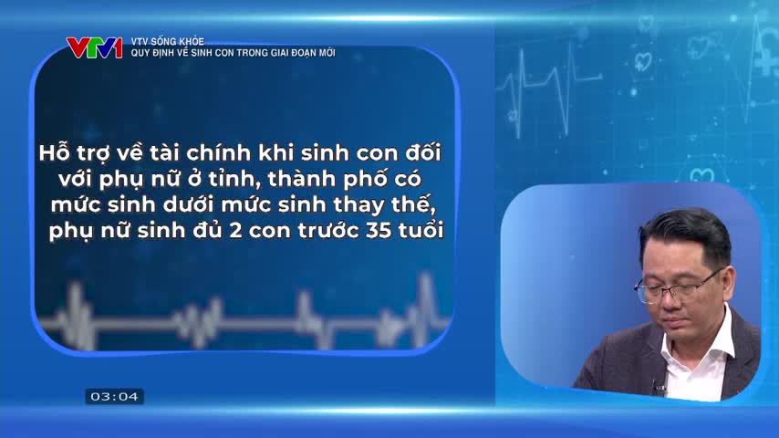 A man in glasses sits and listens intently on a VTV1 health program segment. Text on screen discusses financial support for women having children in areas with low birth rates.